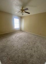 910 Duncan Lane, Unit 61 Austin, TX 78705 - Photo 14 of 22 an empty room with a window and a fan