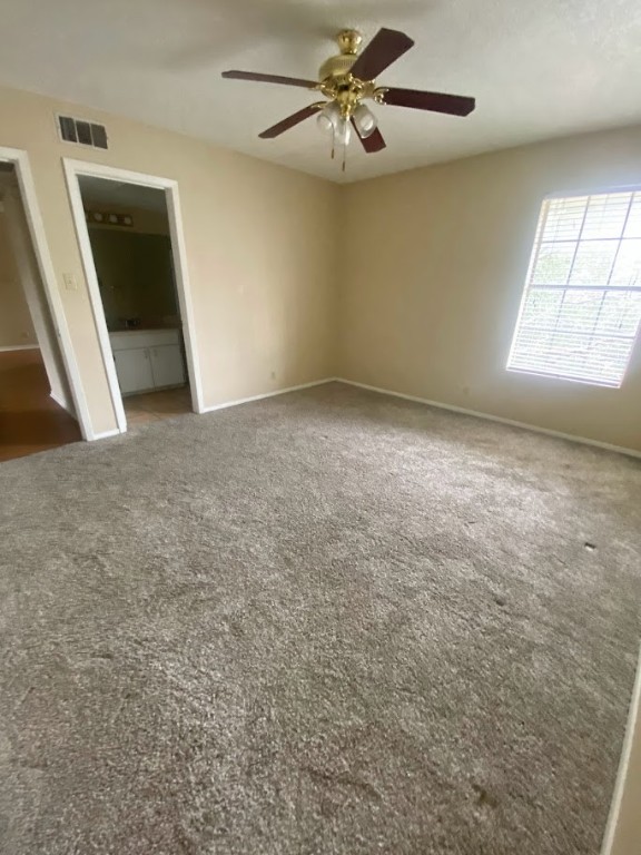 910 Duncan Lane, Unit 61 Austin, TX 78705 - Photo 15 of 22 an empty room with windows and fan