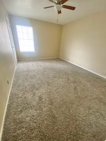 an empty room with a empty space and ceiling fan