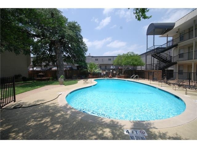 910 Duncan Lane, Unit 61 Austin, TX 78705 - Photo 2 of 22 a view of a swimming pool with a yard