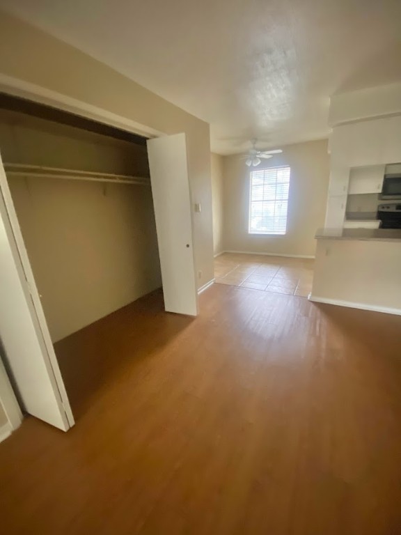910 Duncan Lane, Unit 61 Austin, TX 78705 - Photo 6 of 22 an empty room with a fireplace and windows