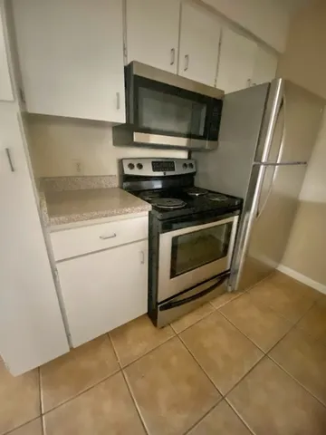 a kitchen with a stove and a microwave
