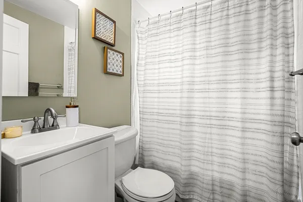 a bathroom with a sink a toilet and mirror