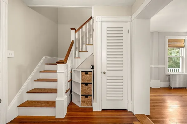 a view of entryway and hall with wooden floor