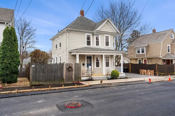 a front view of a house with a street view