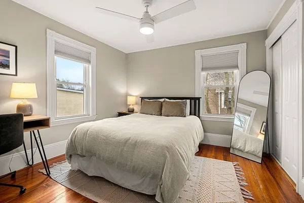a bedroom with a large bed and a window