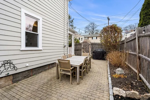 a view of a chairs and table in backyard of the house