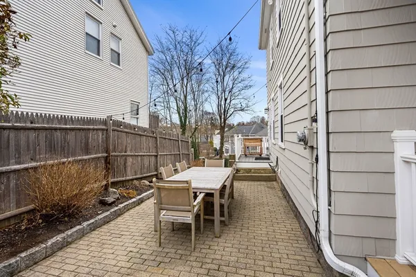a view of a patio with a table and chairs