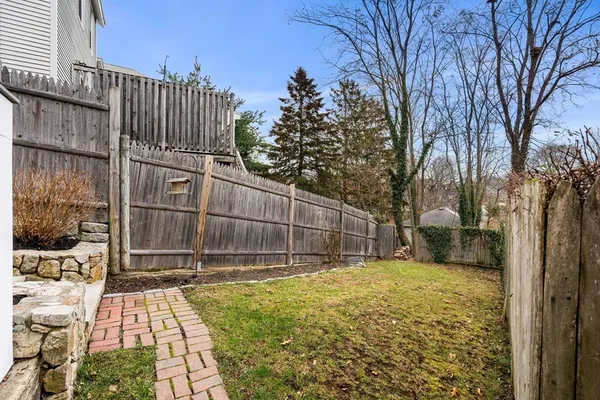 a view of a house with wooden fence