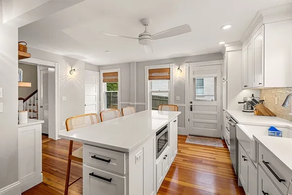 a kitchen that has a lot of counter space and wooden floor