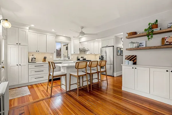 a kitchen with white cabinets and stainless steel appliances