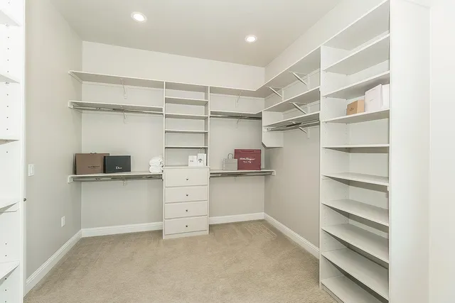 a view of a livingroom with a ceiling fan and window