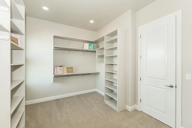 a view of a big room with a ceiling fan and windows