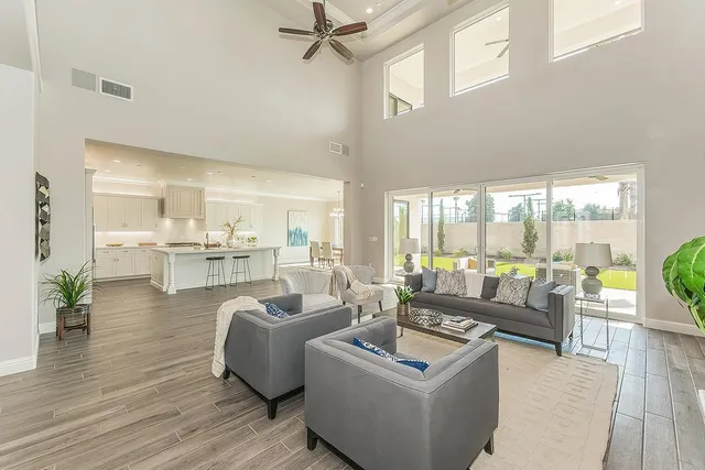 a living room with furniture a large window and a fireplace