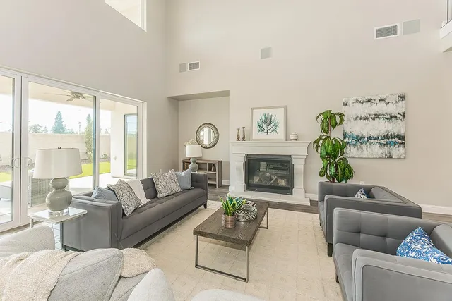 a living room with furniture wooden floor and a table