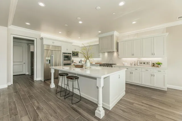 a outdoor kitchen with a dining table wooden floor and a dining table