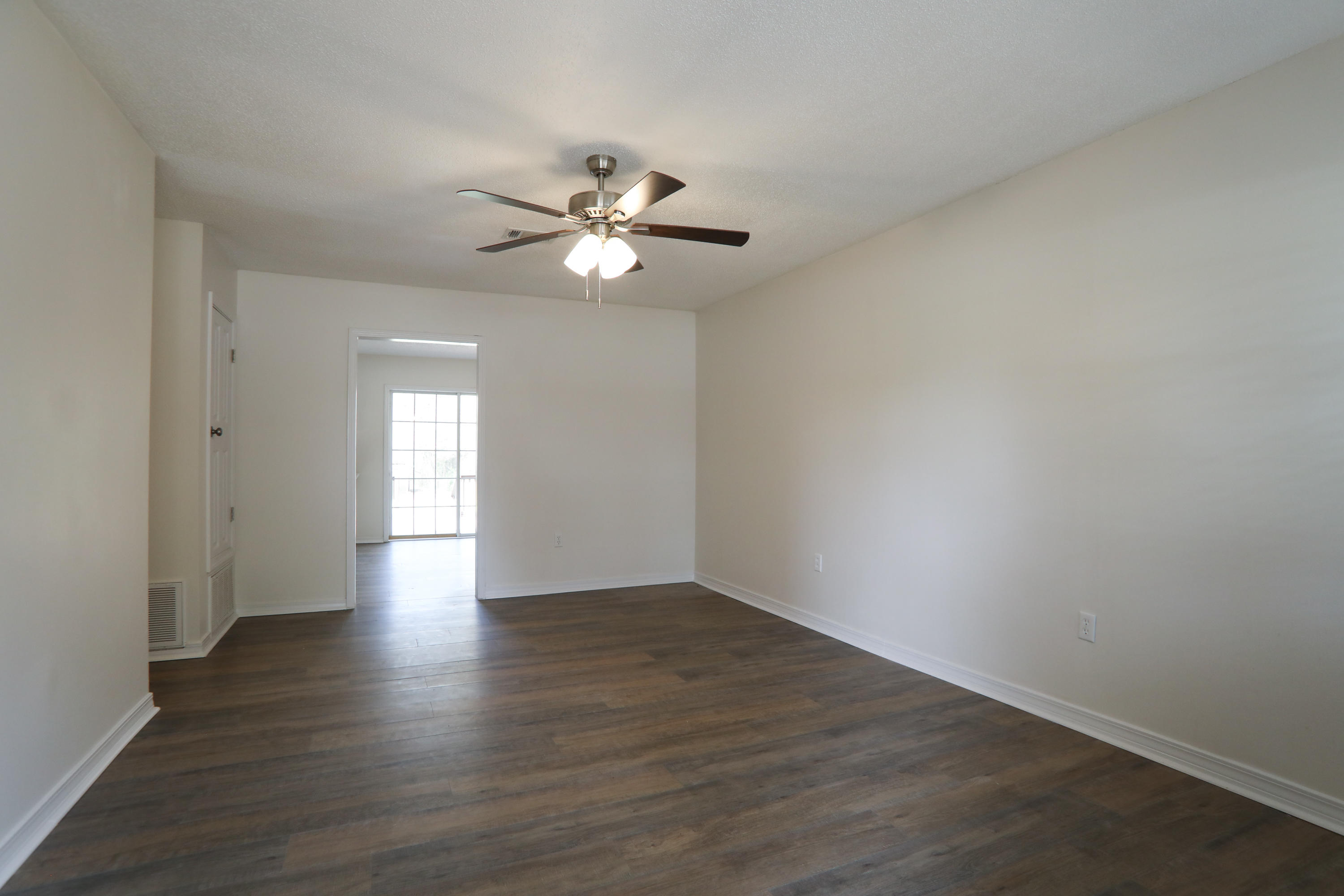 6040 Old Bethel Road Crestview, FL 32536 - Photo 5 of 16 wooden floor in an empty room with a window