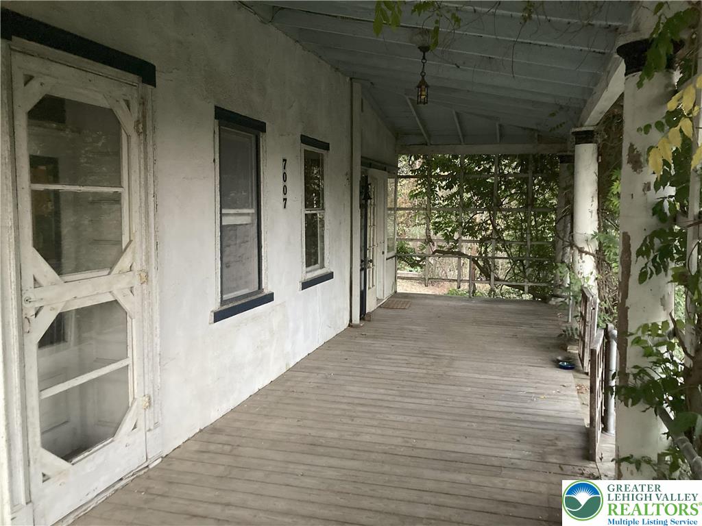 7007 Bausch Road New Tripoli, PA 18066 - Photo 4 of 36 a view of a porch with wooden floor and a potted plant