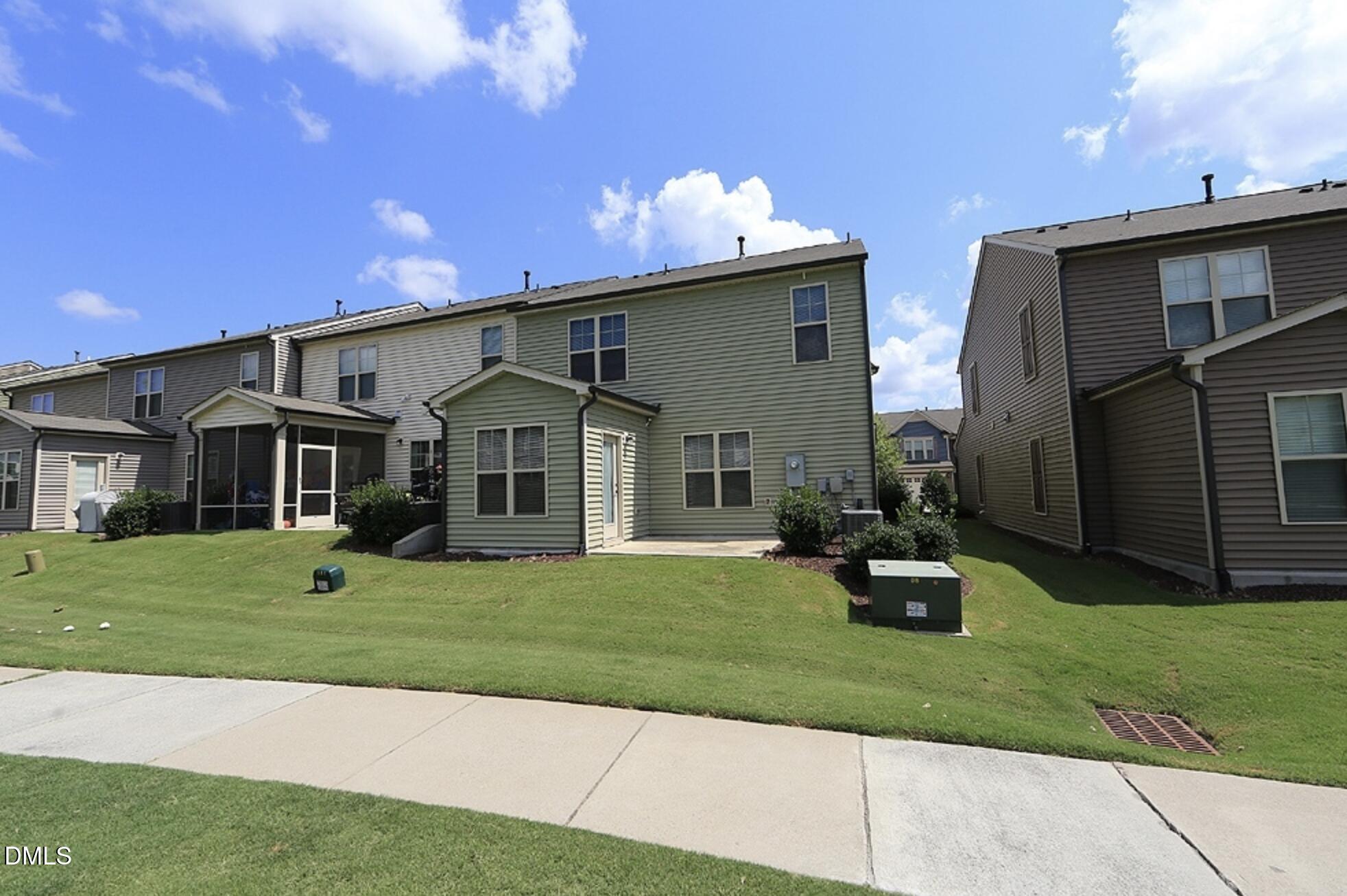 326 Brier Crossings Loop Durham, NC 27703 - Photo 11 of 12 a front view of a house with a yard and garage