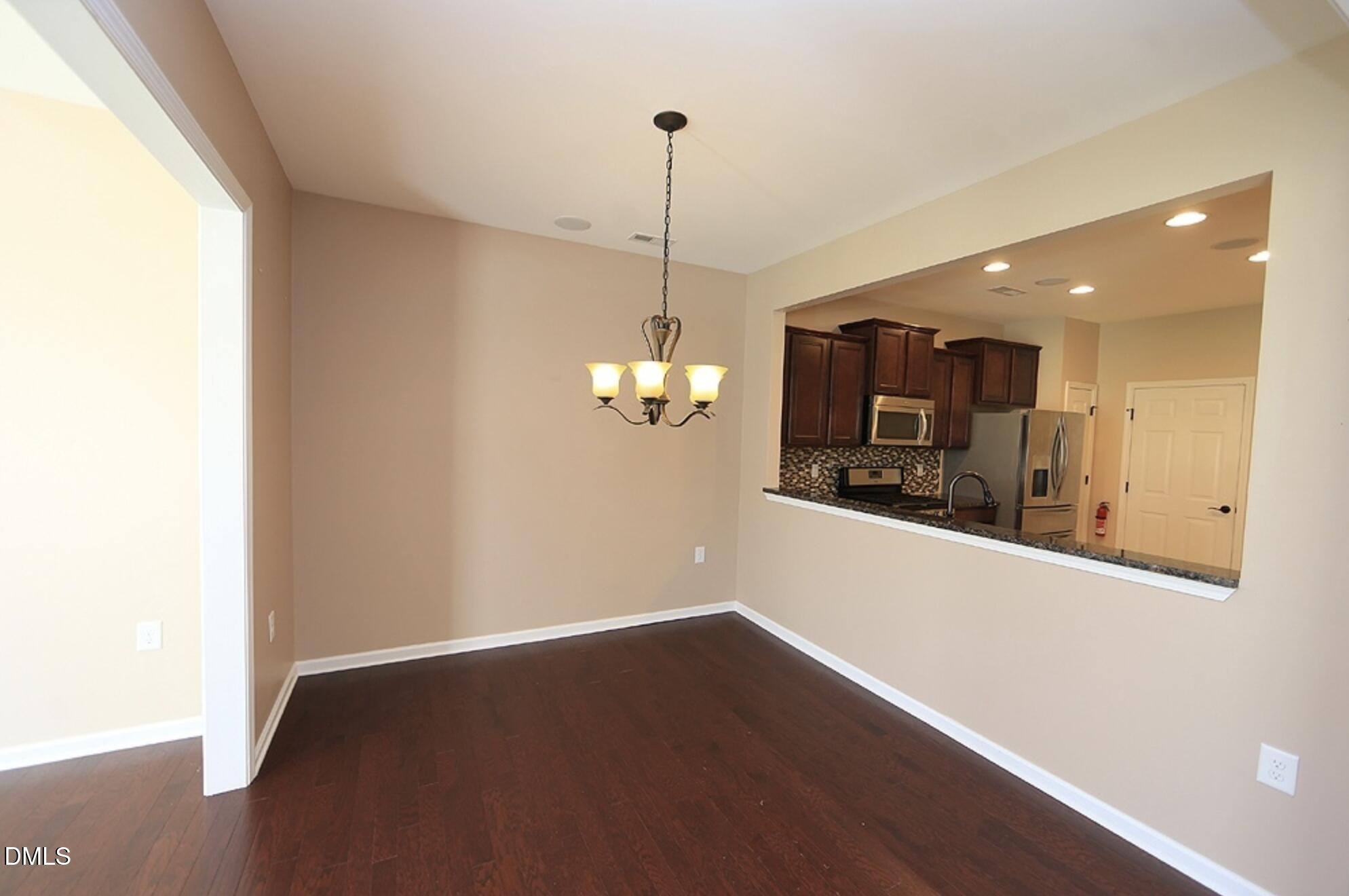 326 Brier Crossings Loop Durham, NC 27703 - Photo 5 of 12 a view of a room with wooden floor and chandelier