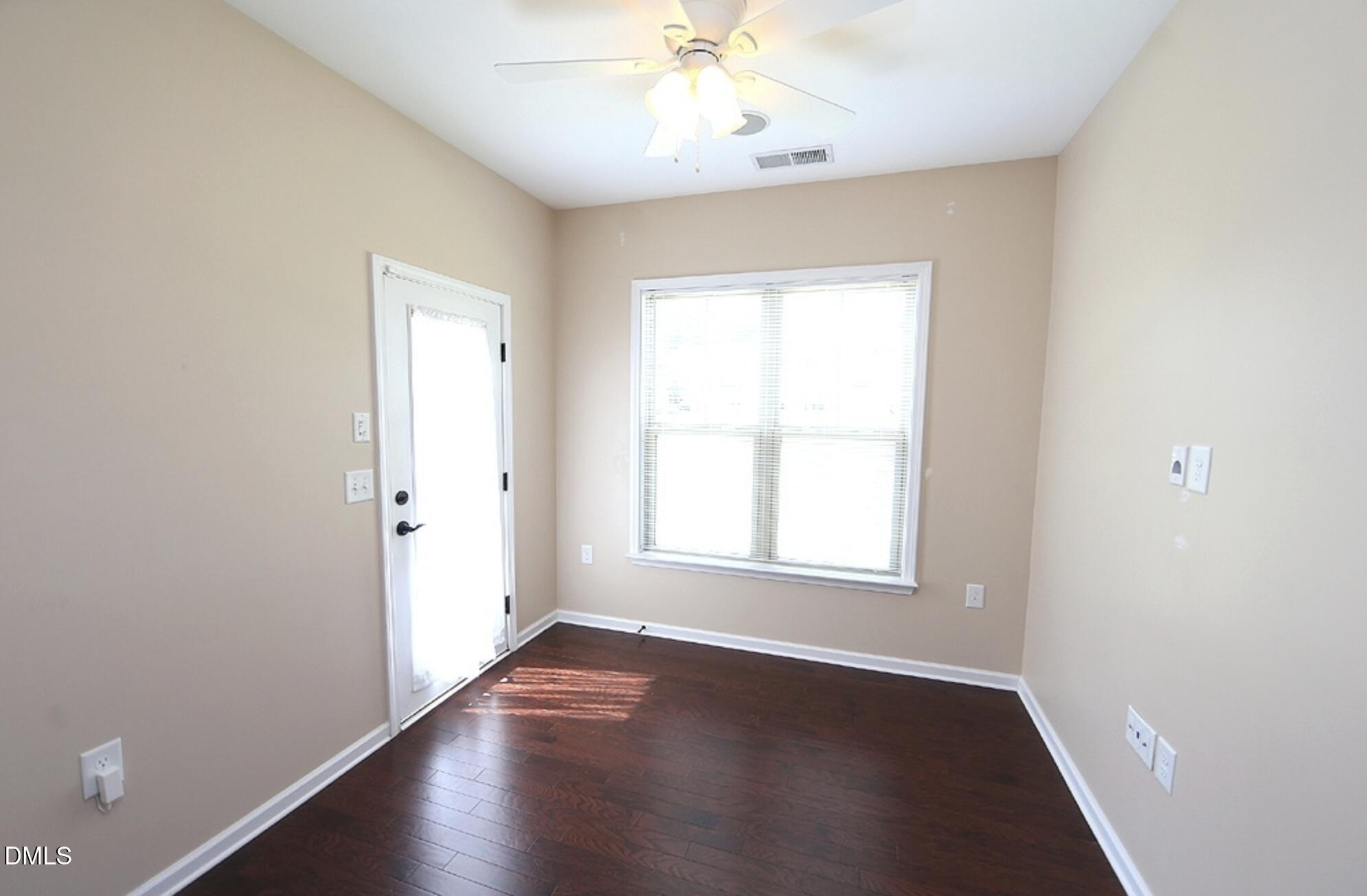 326 Brier Crossings Loop Durham, NC 27703 - Photo 6 of 12 an empty room with wooden floor closet and windows