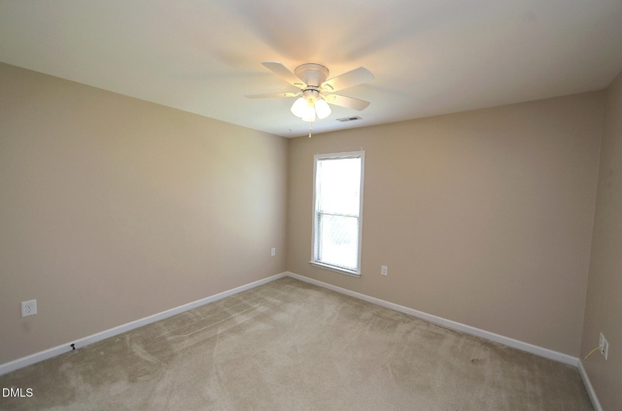 326 Brier Crossings Loop Durham, NC 27703 - Photo 9 of 12 an empty room with a window and a fan