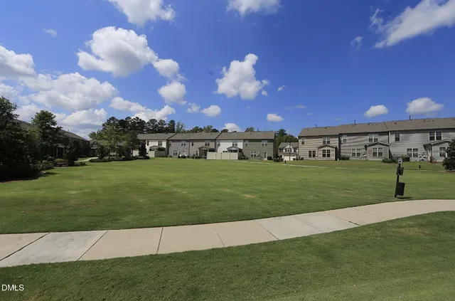a view of a big house with a big yard