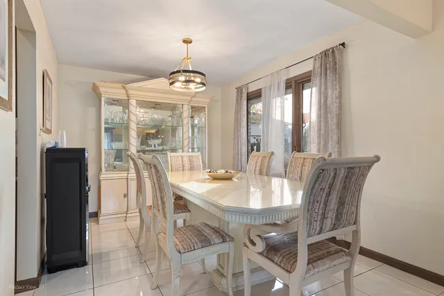 a view of a dining room with furniture wooden floor and chandelier