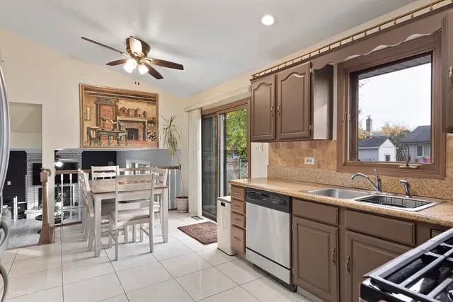 a kitchen with stainless steel appliances granite countertop a refrigerator stove and microwave