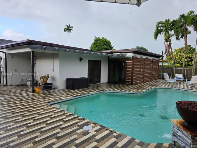 a view of a house with pool porch and chairs