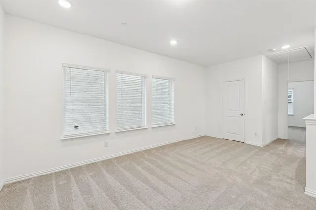 an empty room with a empty space and windows