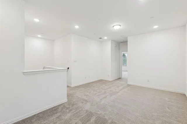 an empty room with closet and windows