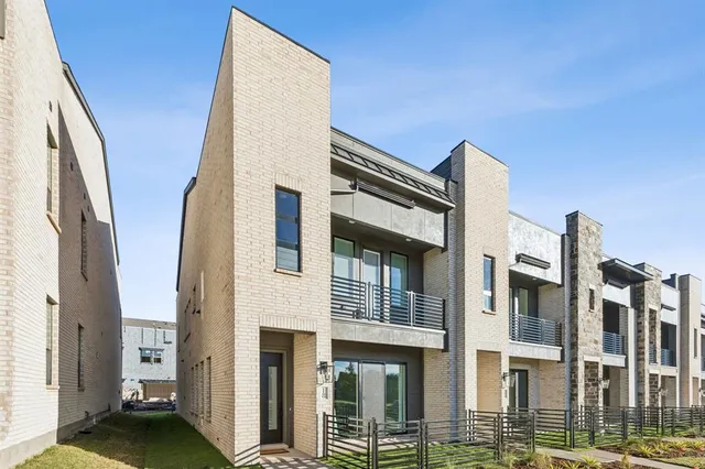 a front view of a building with glass door and brick wall