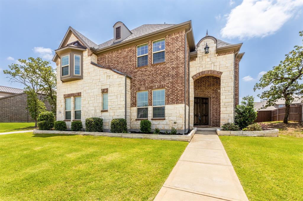 a front view of house with yard and green space