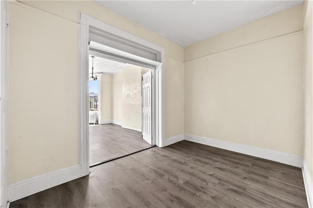 1271 Bushwick Avenue Brooklyn, NY 11207 - Photo 4 of 13 an empty room with wooden floor and door