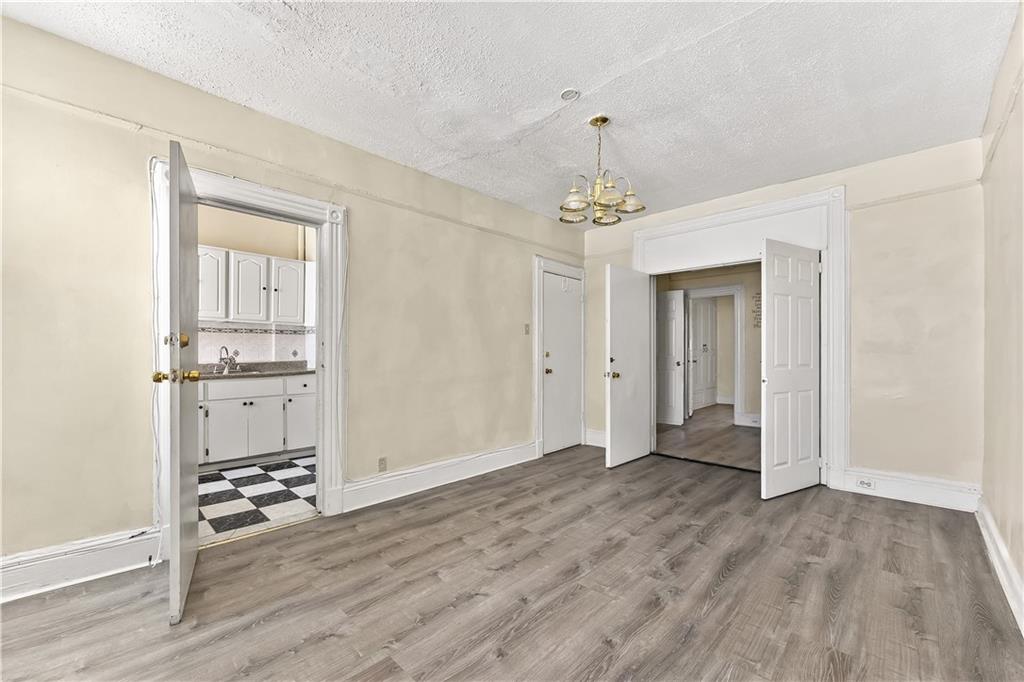 1271 Bushwick Avenue Brooklyn, NY 11207 - Photo 6 of 13 a view of a livingroom with wooden floor