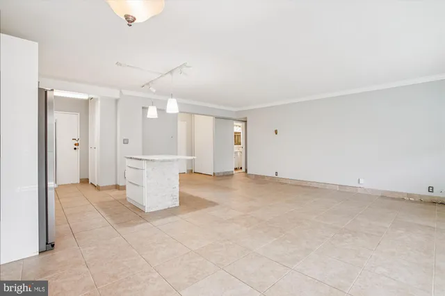 a kitchen with stainless steel appliances kitchen island granite countertop a refrigerator and a sink