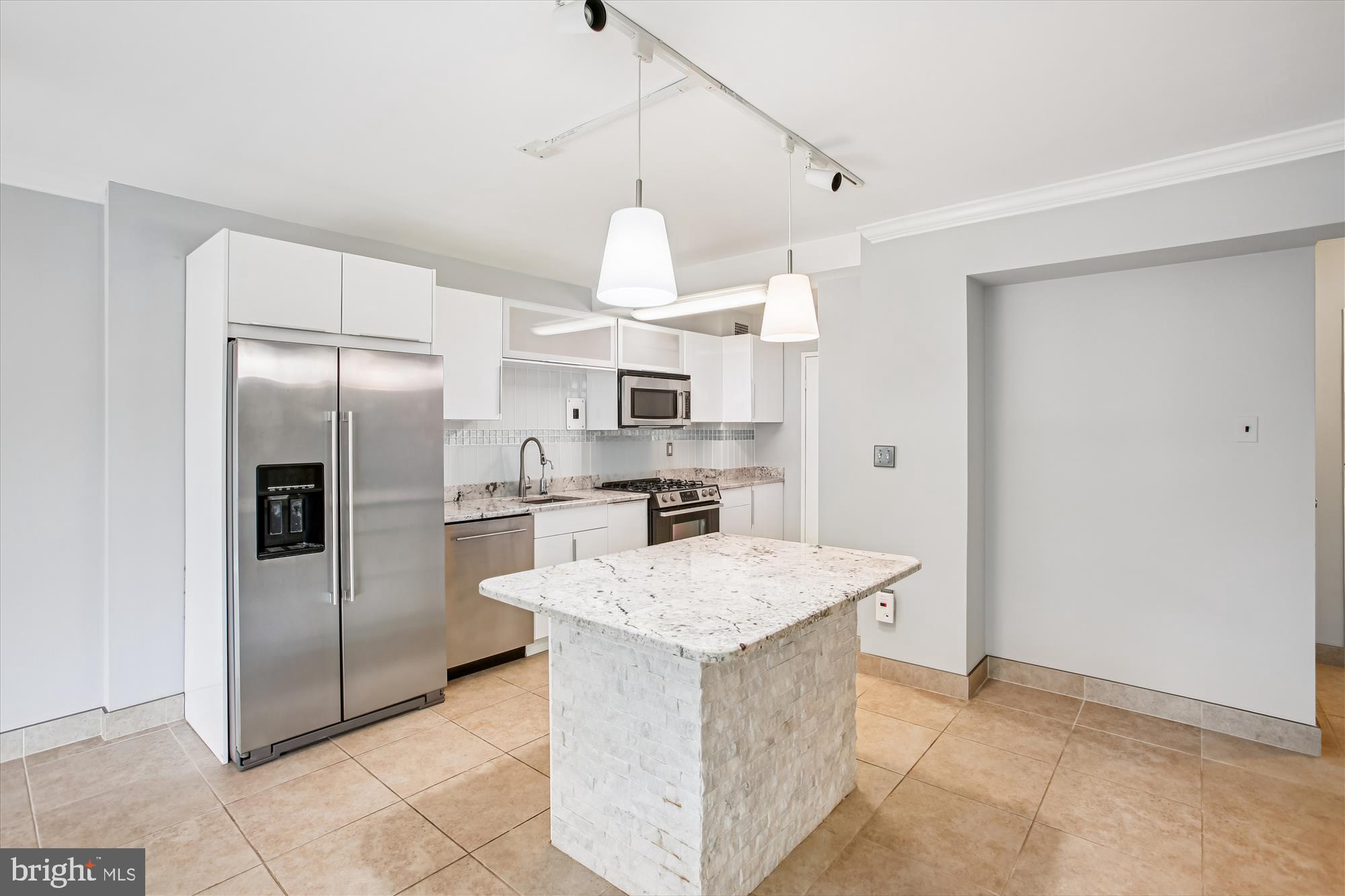 4201 Cathedral Avenue Northwest, Unit 407W Washington, DC 20016 - Photo 14 of 54 a kitchen with granite countertop a refrigerator oven a sink and dishwasher
