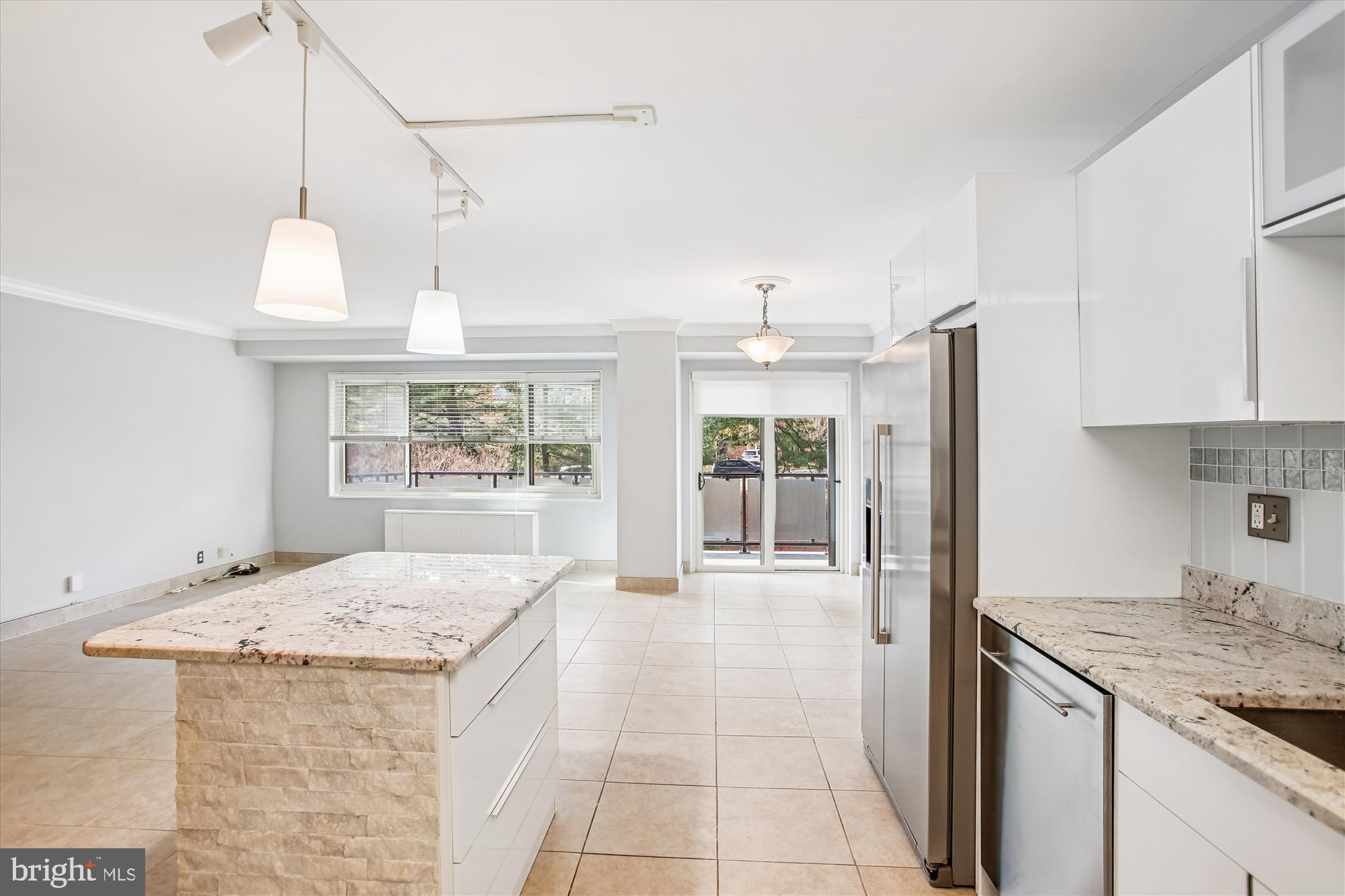 4201 Cathedral Avenue Northwest, Unit 407W Washington, DC 20016 - Photo 16 of 54 a kitchen with a stove a refrigerator a sink dishwasher with a dining table and chairs