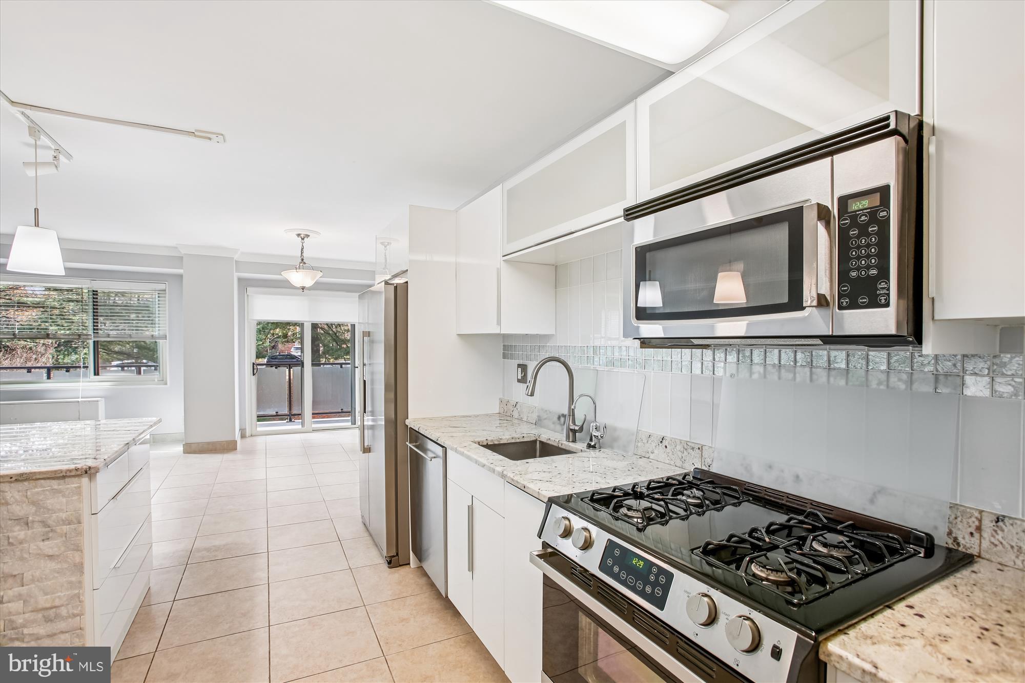 4201 Cathedral Avenue Northwest, Unit 407W Washington, DC 20016 - Photo 17 of 54 a kitchen with a stove and a sink