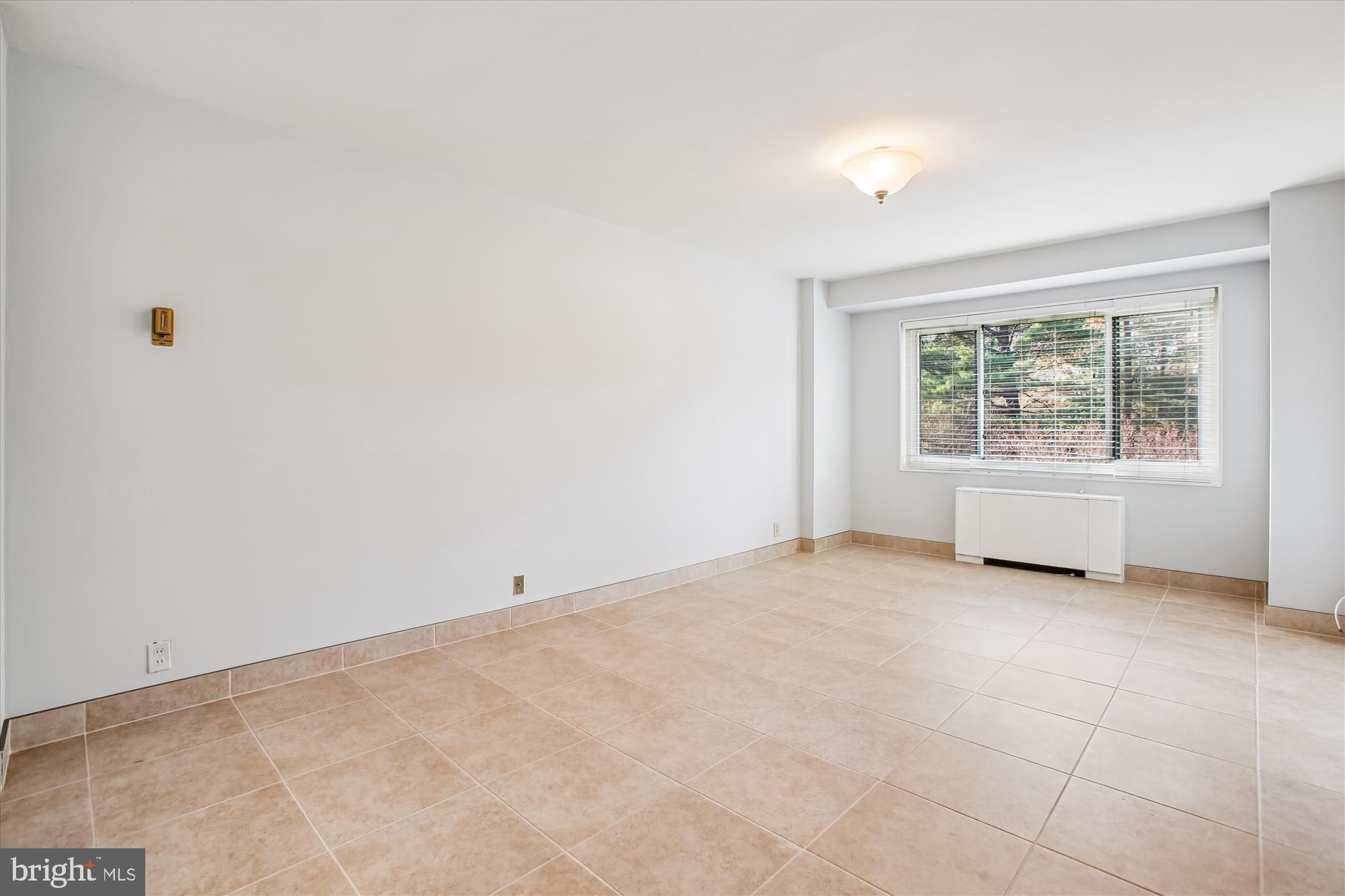 4201 Cathedral Avenue Northwest, Unit 407W Washington, DC 20016 - Photo 23 of 54 an empty room with windows