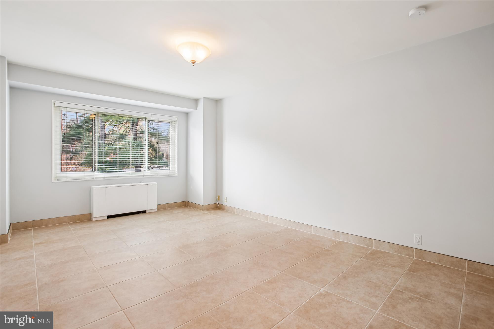 4201 Cathedral Avenue Northwest, Unit 407W Washington, DC 20016 - Photo 24 of 54 an empty room with windows