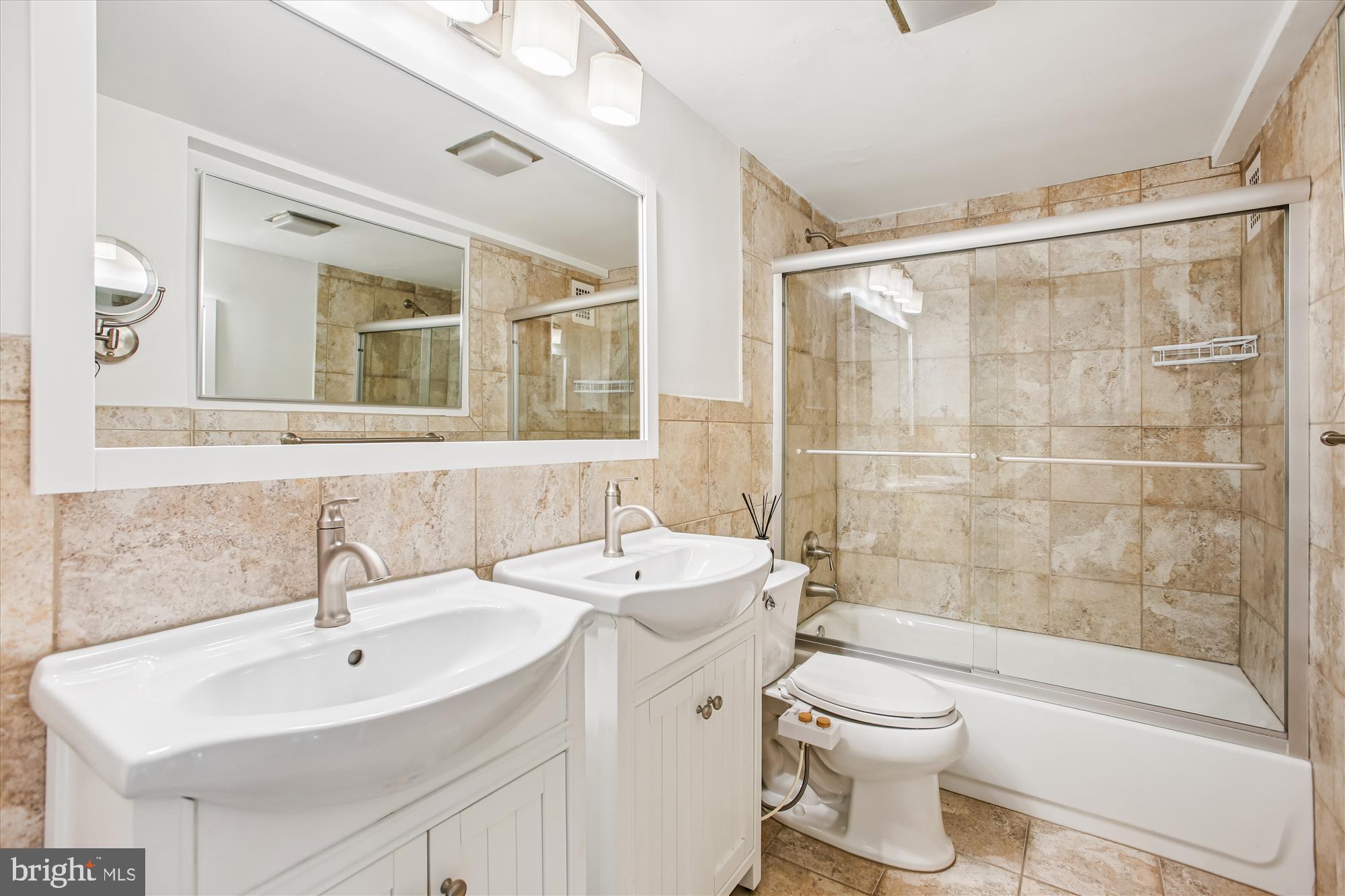 4201 Cathedral Avenue Northwest, Unit 407W Washington, DC 20016 - Photo 26 of 54 a bathroom with a sink toilet and shower