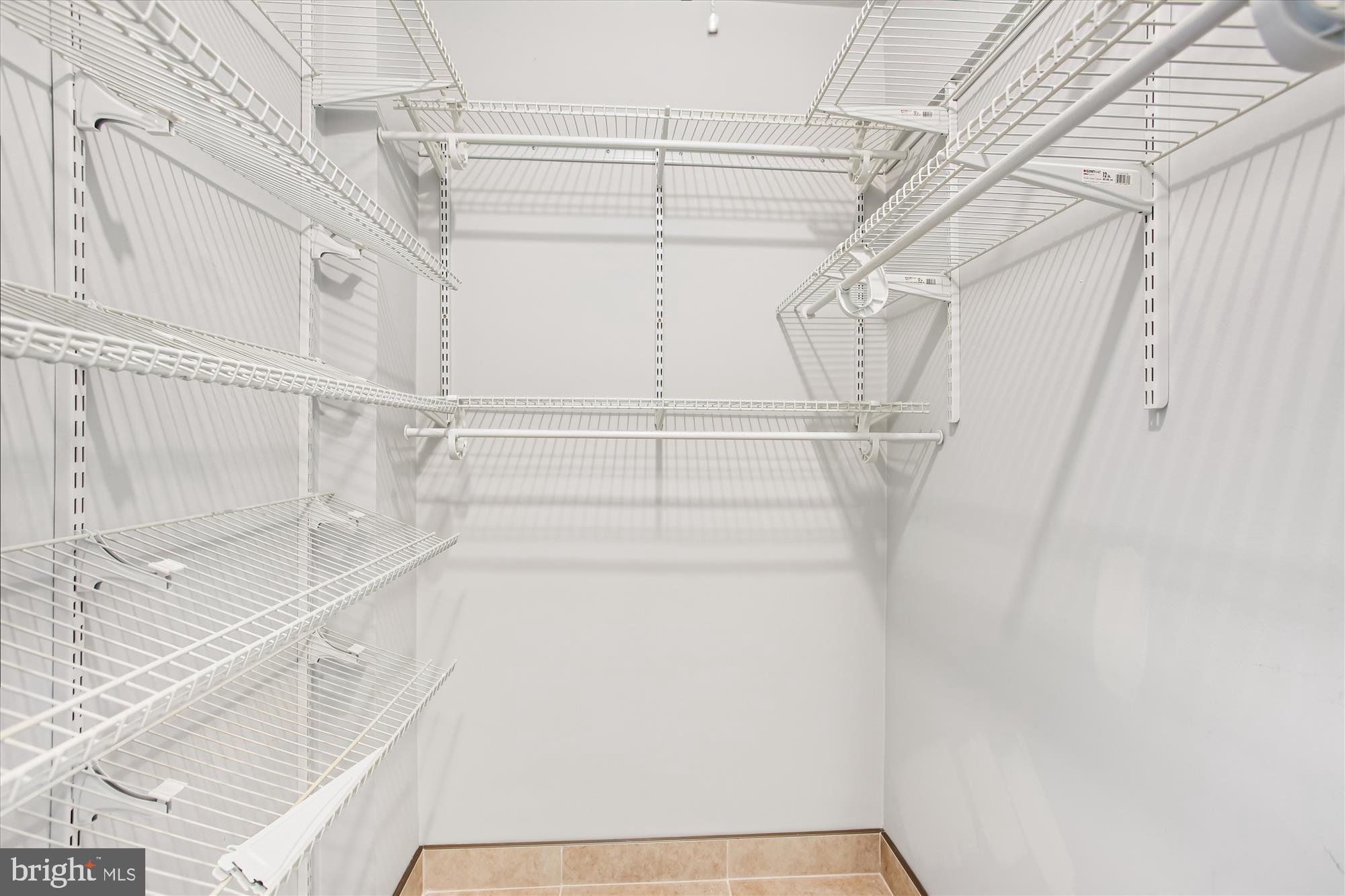 4201 Cathedral Avenue Northwest, Unit 407W Washington, DC 20016 - Photo 27 of 54 a view of walk in closet with empty racks