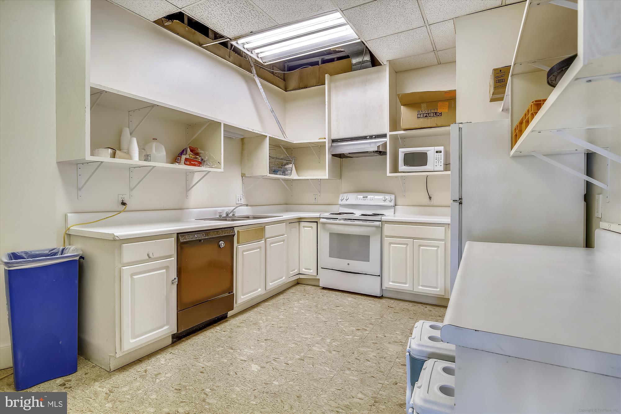 4201 Cathedral Avenue Northwest, Unit 407W Washington, DC 20016 - Photo 43 of 54 a kitchen with white cabinets and white appliances