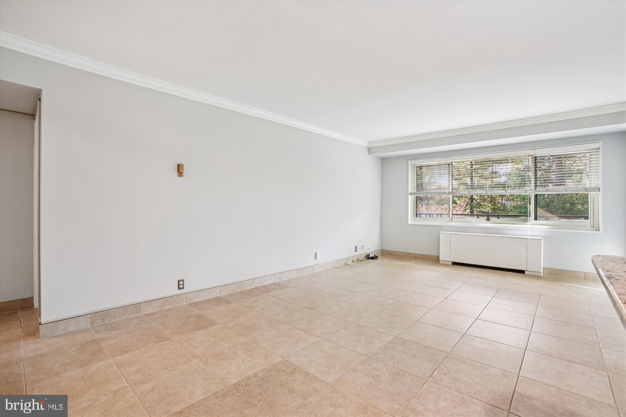 4201 Cathedral Avenue Northwest, Unit 407W Washington, DC 20016 - Photo 7 of 54 a view of an empty room with a window