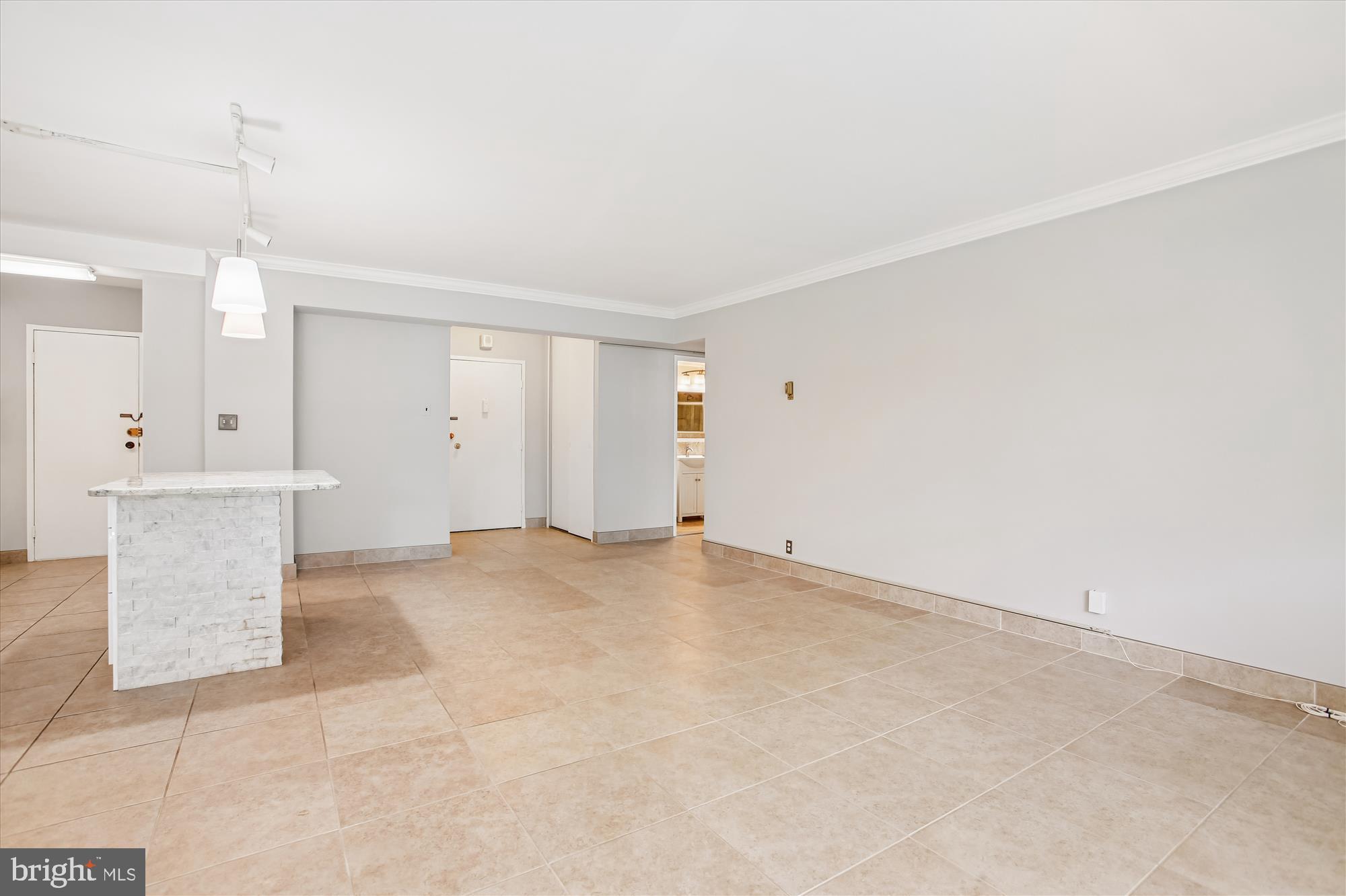 4201 Cathedral Avenue Northwest, Unit 407W Washington, DC 20016 - Photo 9 of 54 a view of an empty room with a window