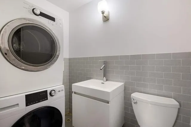 a bathroom with a sink toilet and mirror