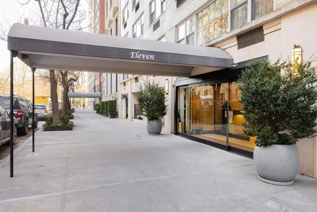 a living room with furniture and large windows