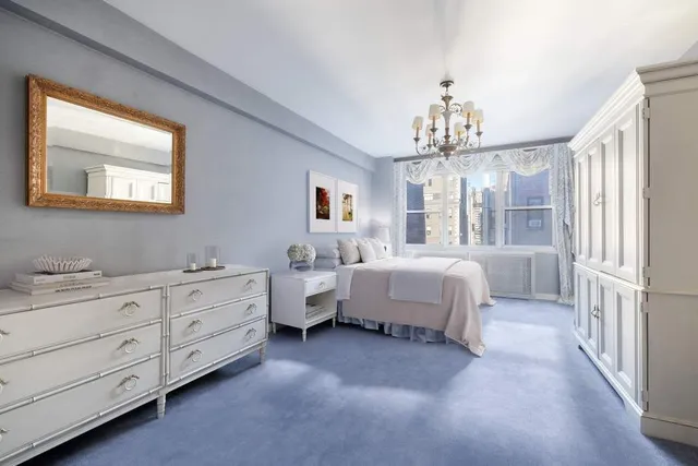 a bathroom with a granite countertop double vanity sink a mirror and a shower